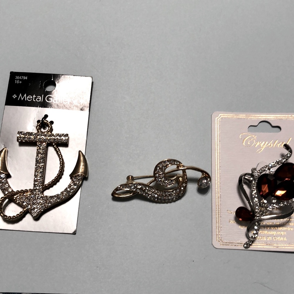 One pendant and two brooches